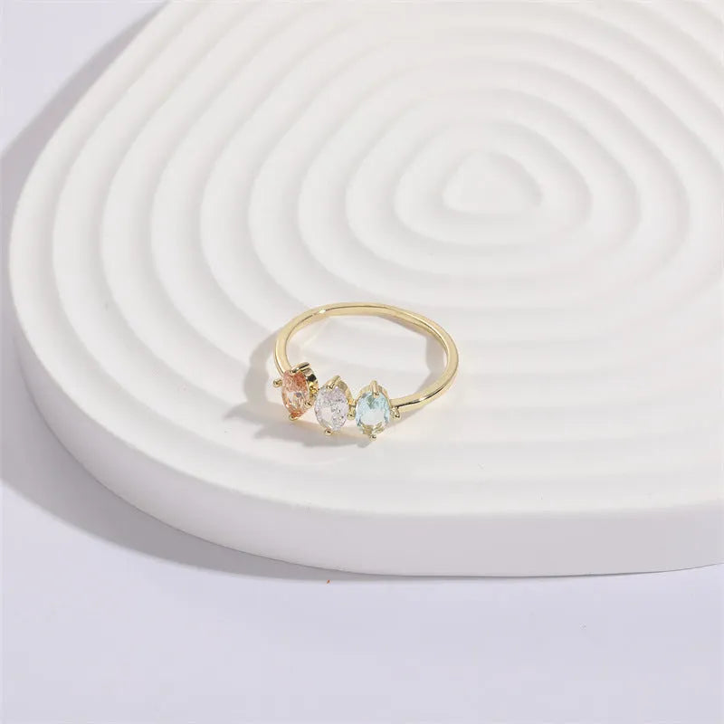 Geometric triangle ring with tricolour zircon stones in horse eye pattern and gold colour finish
