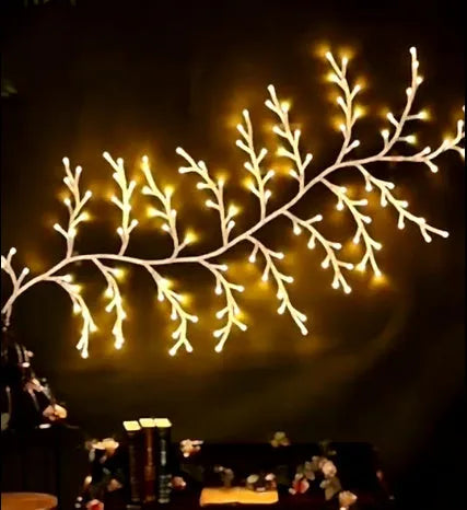 Flexible LED vine light garland with warm white lights on textured birch-bark branches, shaped decoratively.