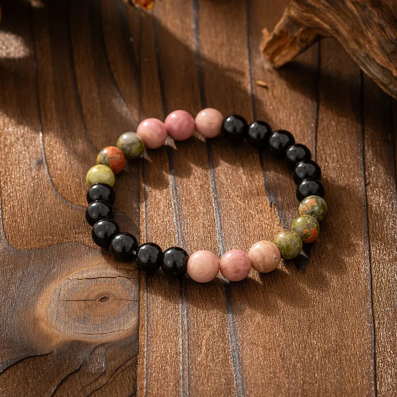 Vintage bohemian style natural stone bead necklace and bracelet set showing geometric round beads and tassel detailing