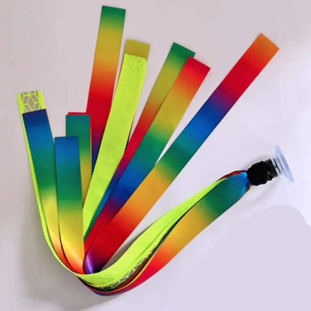 Colourful decorative ribbon streamers attached to a children safety helmet for skating or skiing