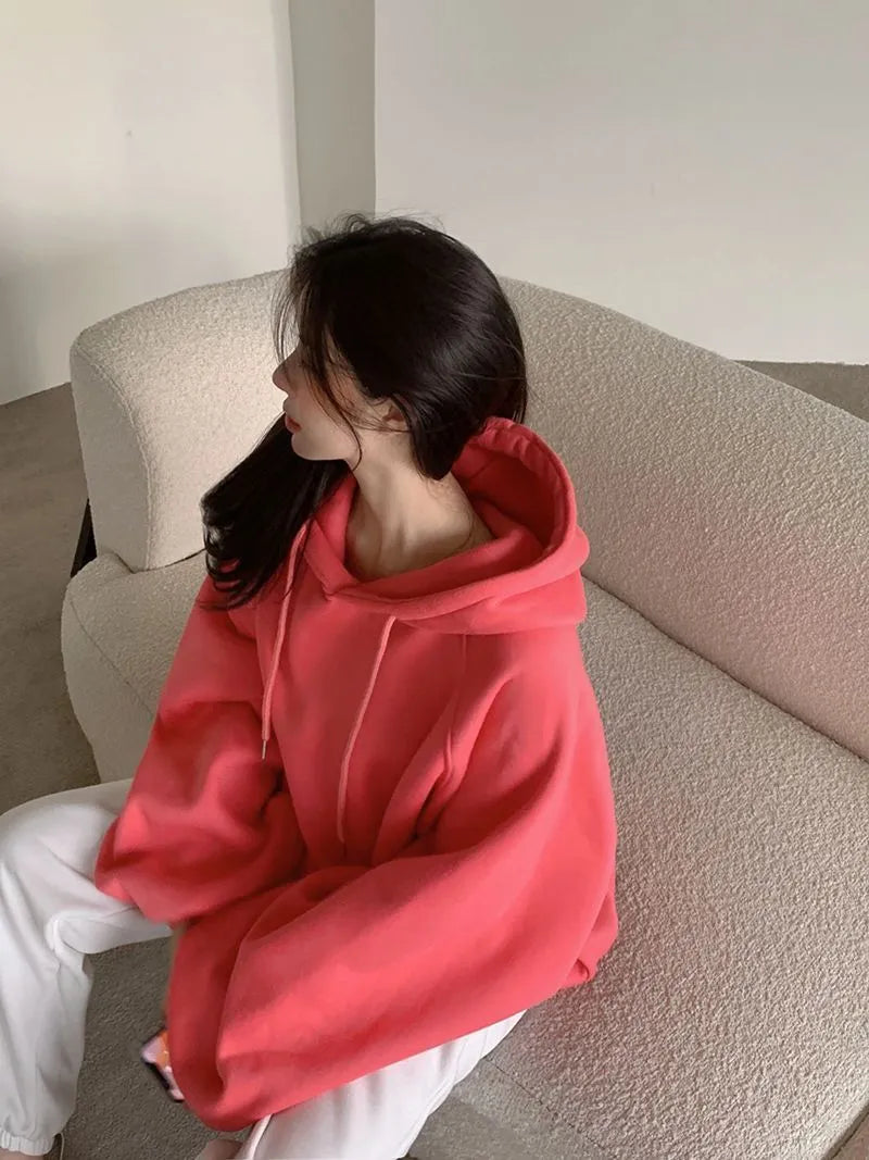 Watermelon red women's loose fit mulberry silk hooded sweater on a hanger.