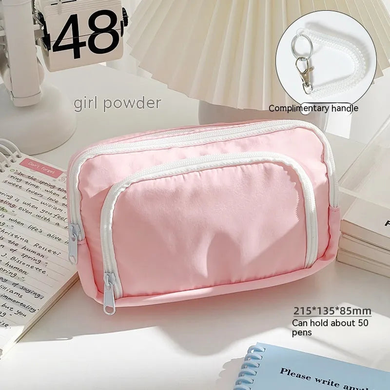 Double-layer pencil case in mint green with gift handle, showing internal divider for stationery organisation