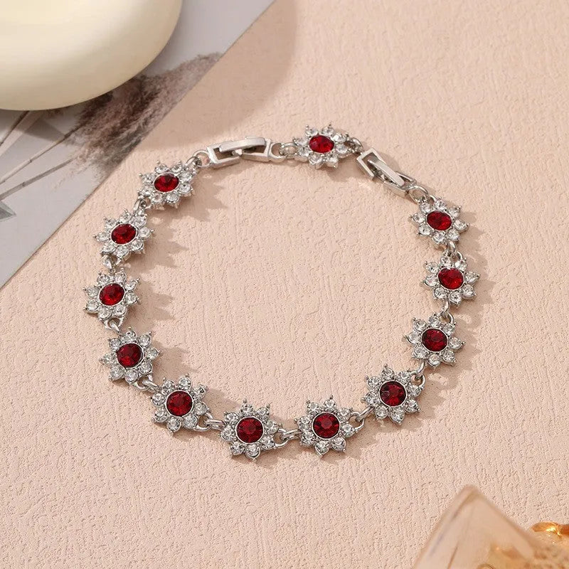 Floral zinc alloy bracelet with electroplated gold or silver finish and gemstone colour variants