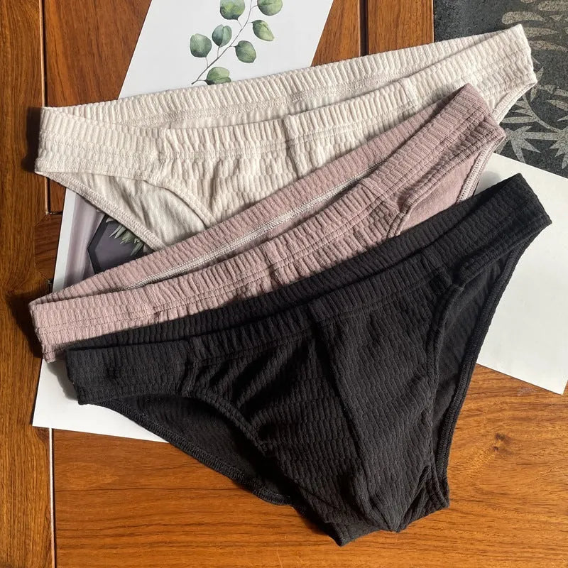 Men's solid colour pure cotton triangle briefs with a mid-waist body-shaping design.