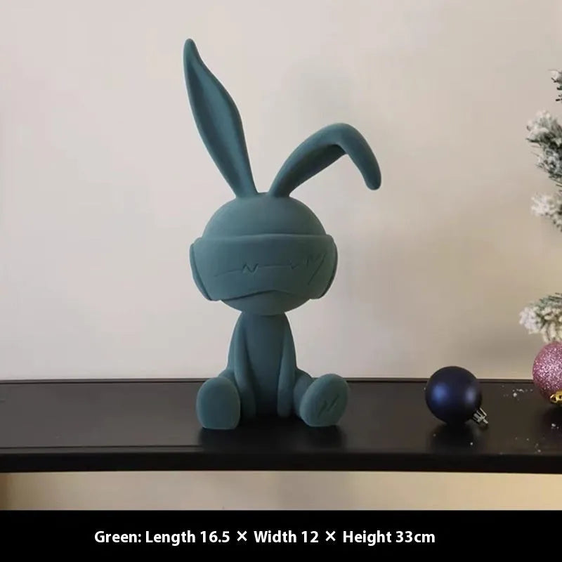 Suede blindfold rabbit resin table ornament in chosen colour on a wooden surface.
