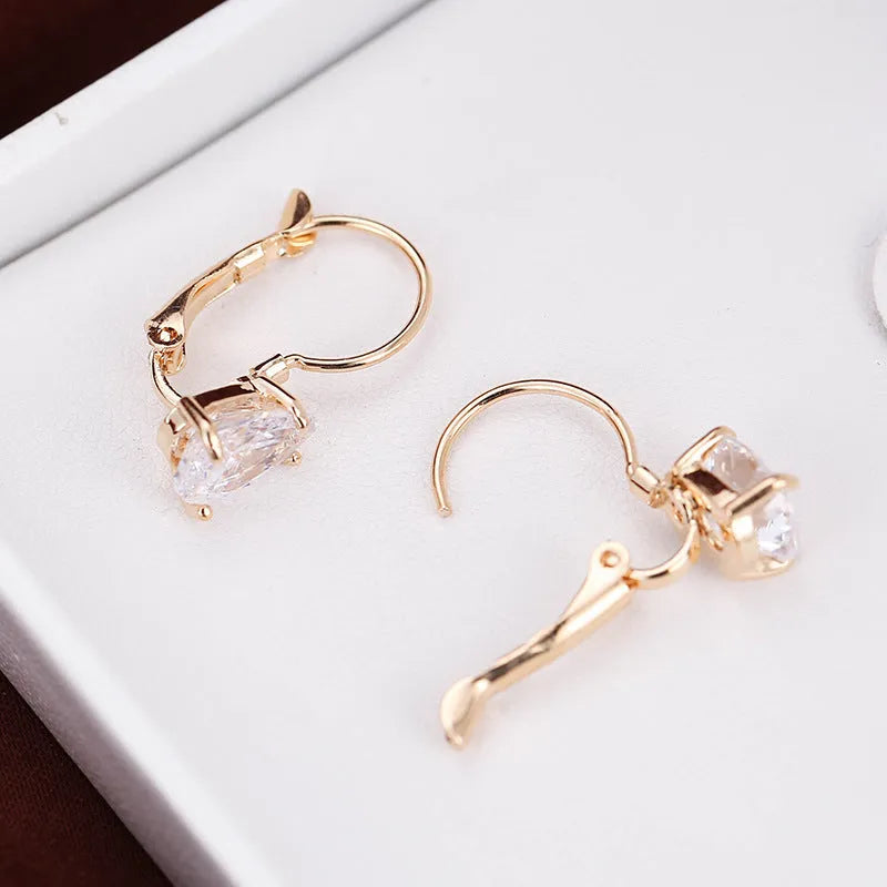 Gold and platinum coloured drop-shaped fashion earrings with metallic finish