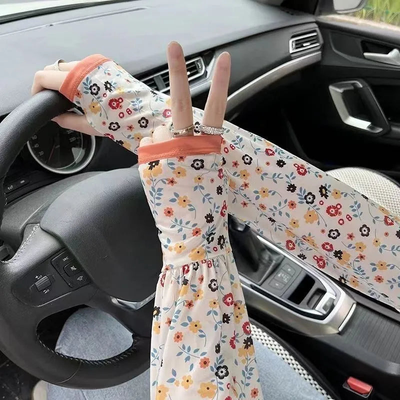Printed viscose fibre sun protection oversleeves in floral design with elasticated cuffs.