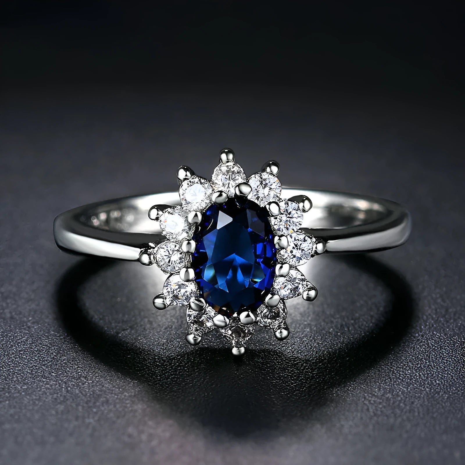 Women's blue moissanite and copper floral ring on a finger, showing zirconium inlay and electroplated colour.