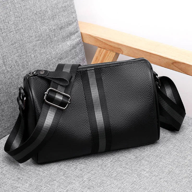 Black genuine leather crossbody shoulder bag showing 24cm height with polyester lining