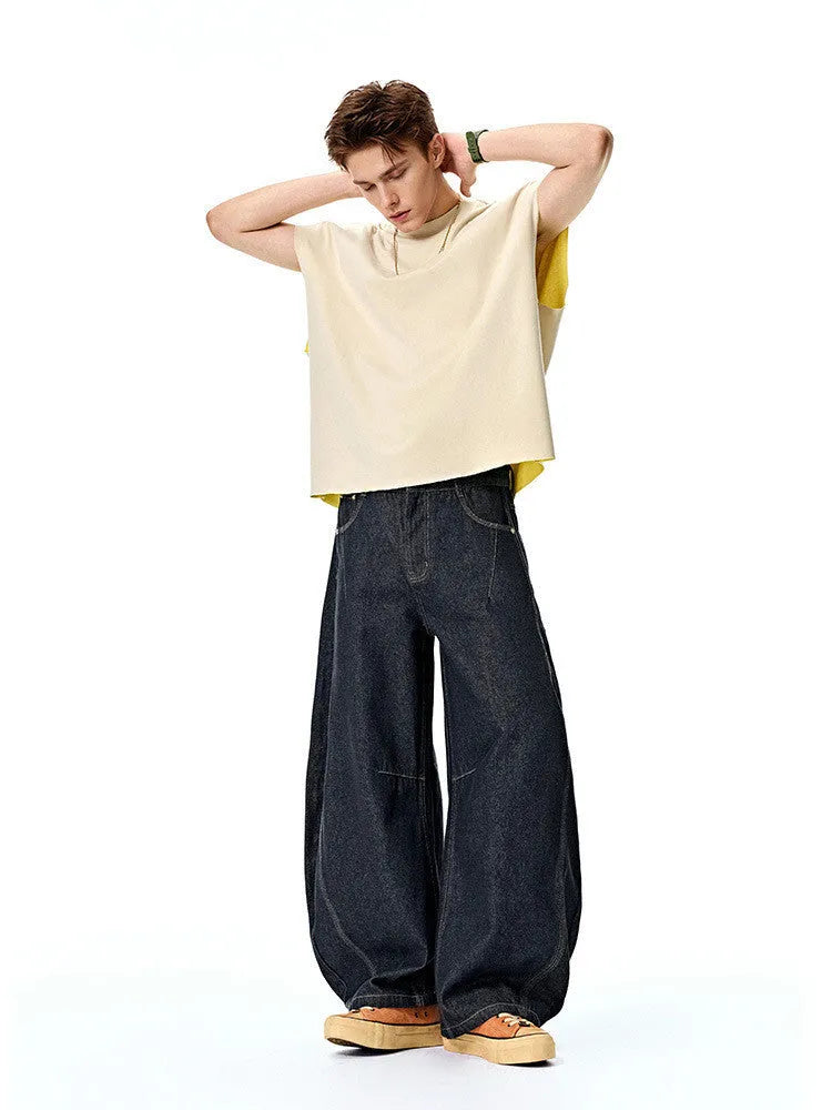 Men's wide leg denim trousers in original cow colour, showing relaxed fit and mid waist design