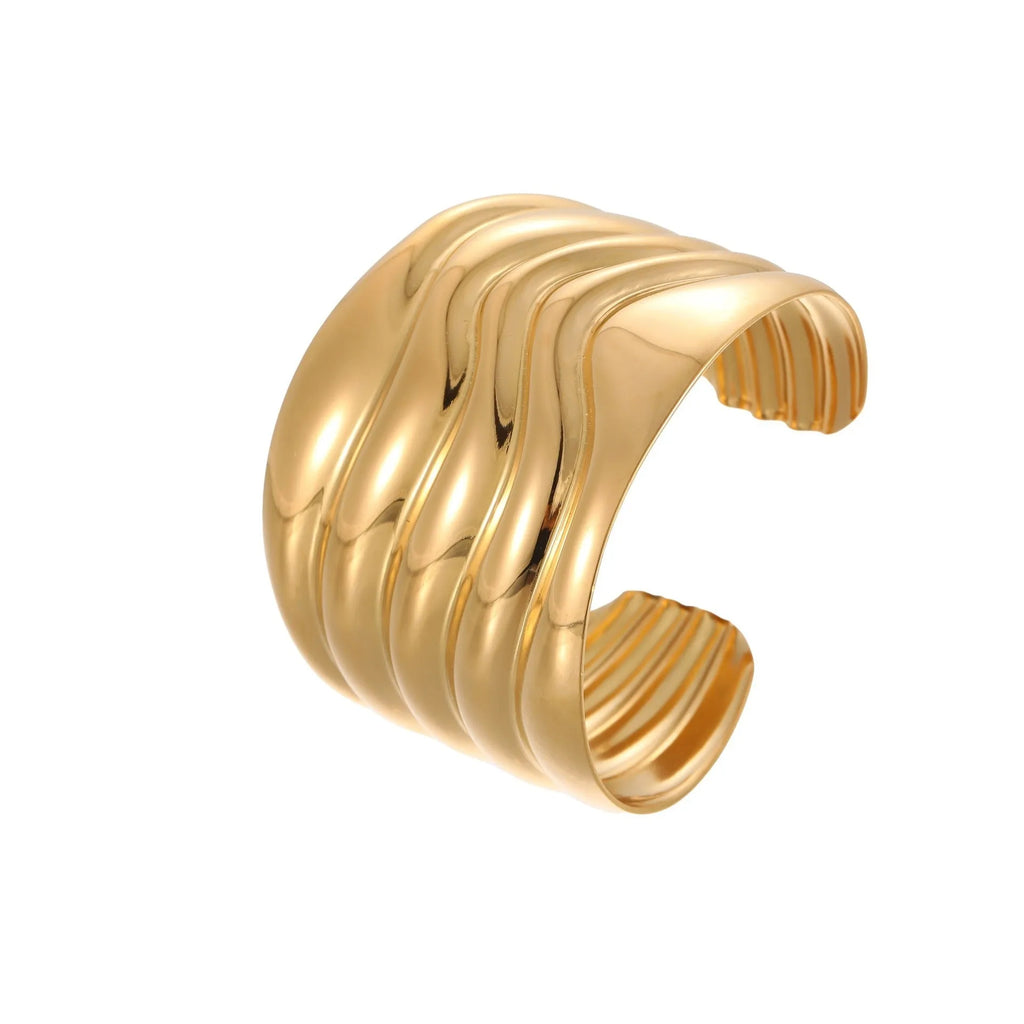 Women's wide stainless steel bracelet with 18K gold plating, geometric wave design, and niche opening closure.