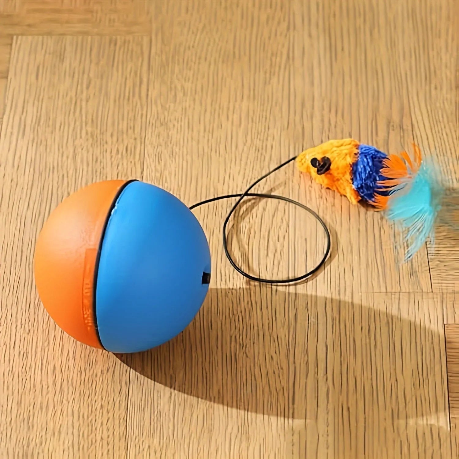 Grey and orange interactive cat toy ball with a soft plush mouse attachment for feline exercise.