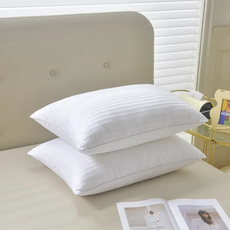 White cotton feather pillow with satin stripe detail, shown in low, medium, and high loft options.