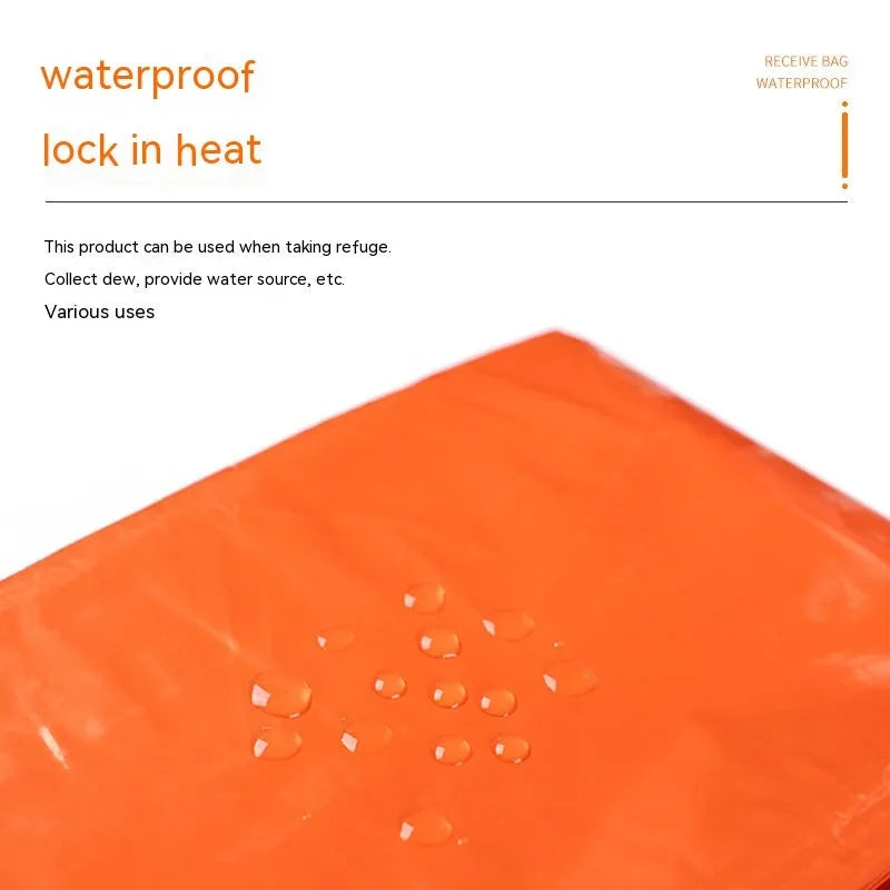 Orange emergency relief tent with sleeping bag and raincoat in temporary outdoor shelter setup
