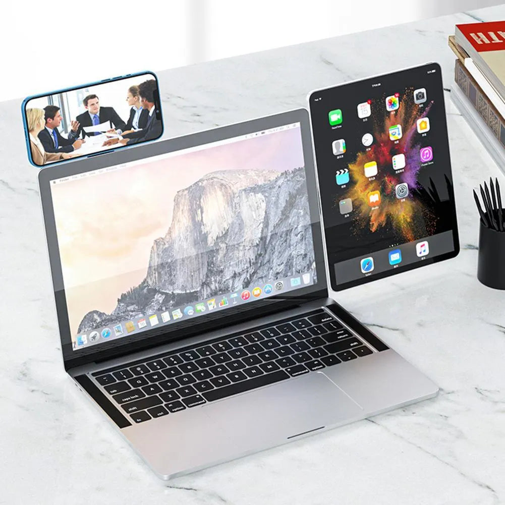 Black magnetic laptop phone holder with foldable aluminium bracket attached to a laptop screen