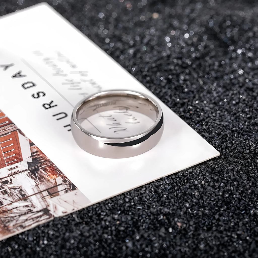 Polished silver titanium steel unisex ring shown in 2mm, 4mm, and 6mm width options.