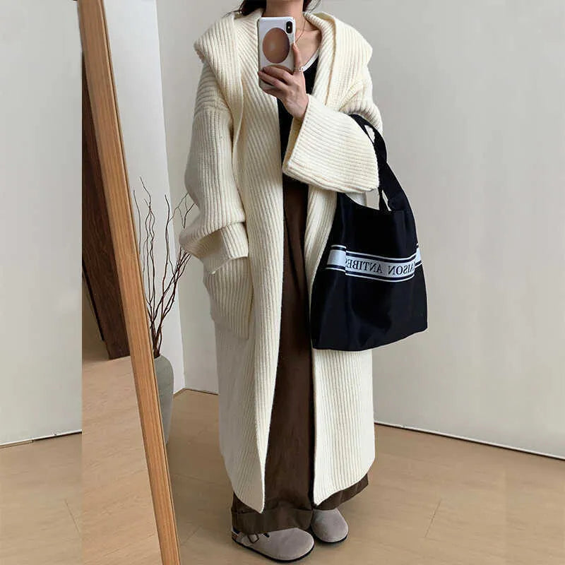 Women's loose grey hooded cardigan coat with raglan sleeves on a hanger