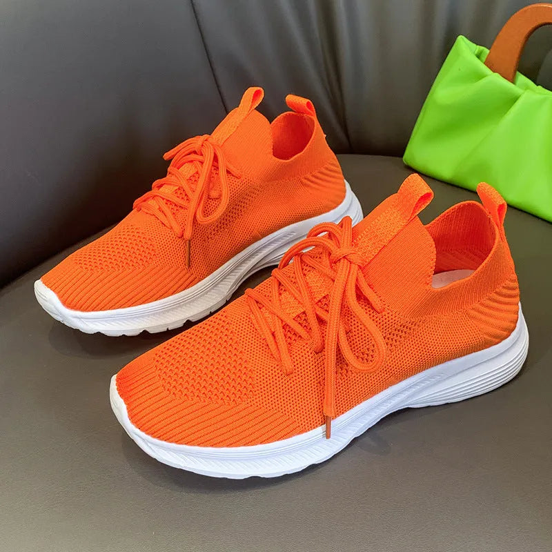 Women's low-top mesh running shoes in creamy white with a rubber sole and round toe.