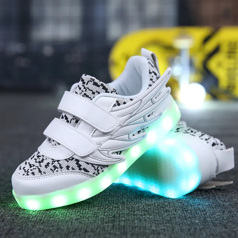 Plum red and white children's LED light-up sneakers showing USB charging port and hidden colour-selector switch.
