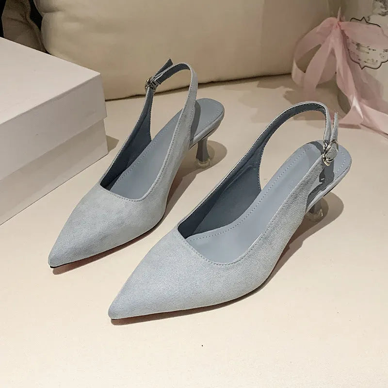 Apricot suede stiletto high heels with a pointed toe and rubber sole on a plain background.