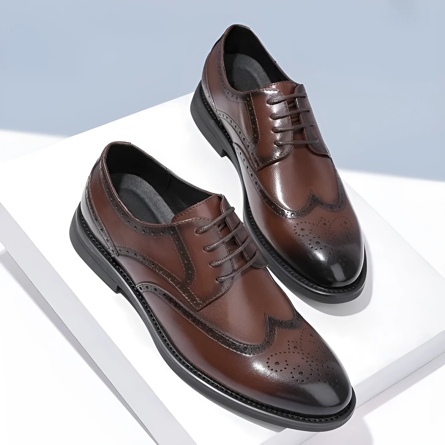 Men's black brogue leather shoes in a business style on a white background.