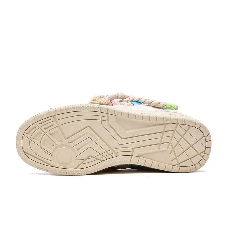 Creamy white retro low-top skate shoes with lace-up front and decorative stitching on a rubber sole.