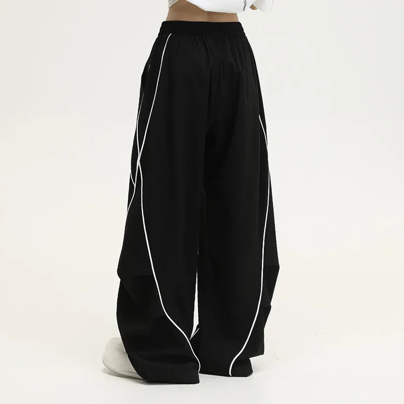 Black striped pleated hip hop wide-leg trousers with mid waist on mannequin