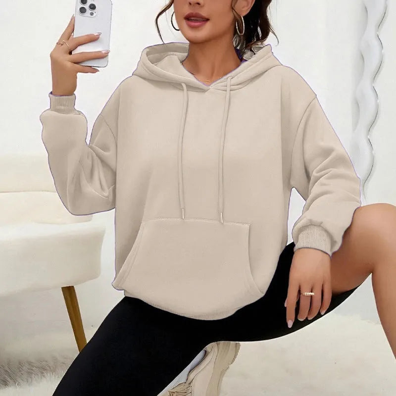Women's loose grey drawstring pocket sweatshirt with long sleeves on a hanger.