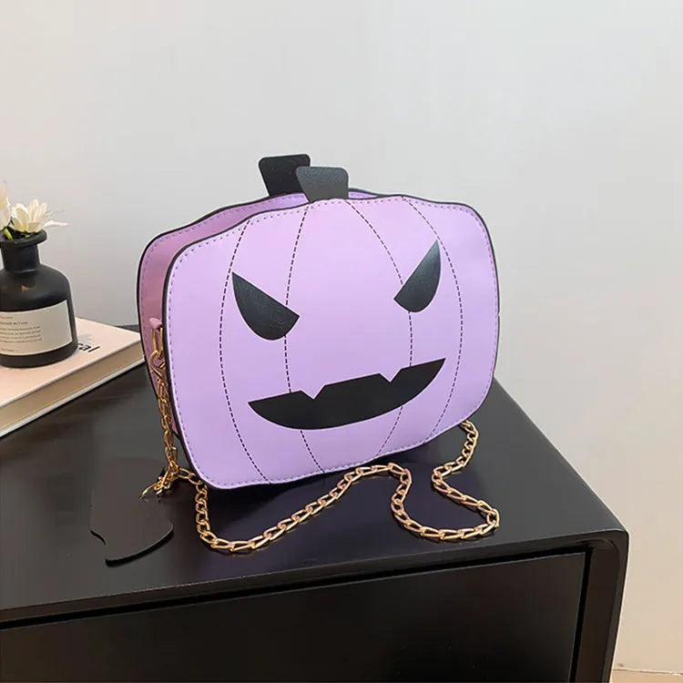 Cartoon pumpkin shoulder bag in orange with chain strap on white background