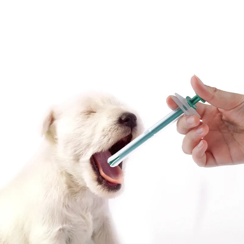 Two pet pill shooter syringes with soft silicone tips for administering tablets to cats and dogs