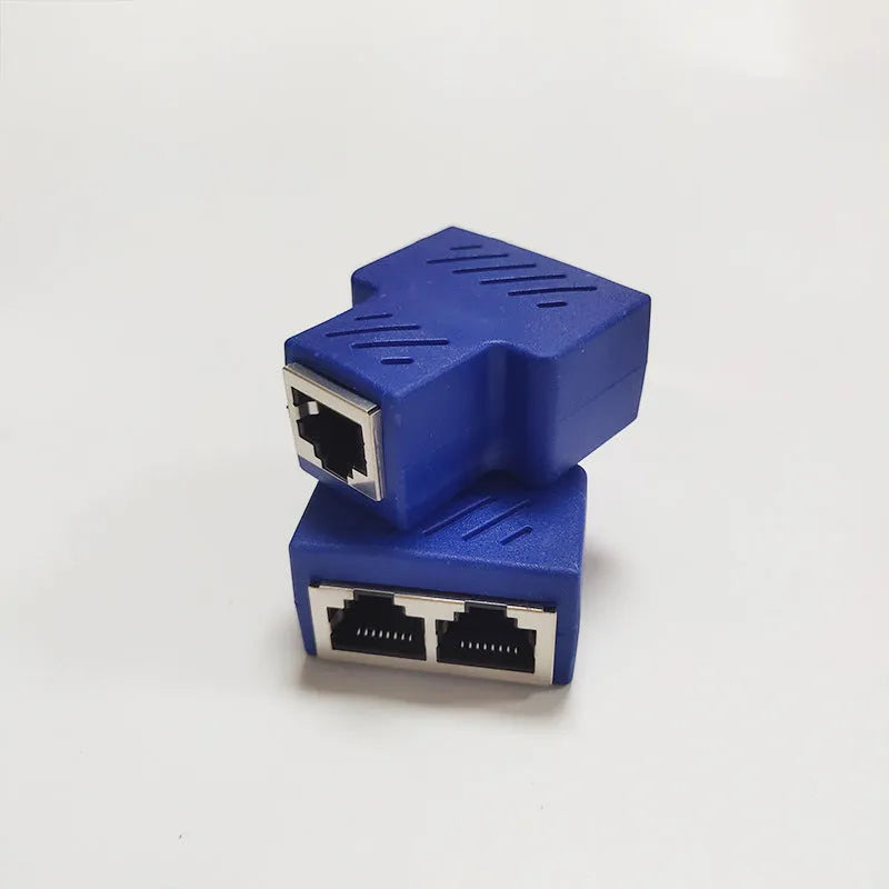 Two white RJ45 network cable splitters showing three female Ethernet ports each.