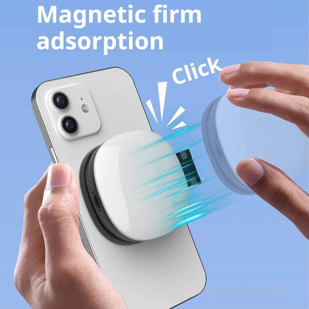 Black mini portable fill light with dial control magnetically attached to a mobile phone.
