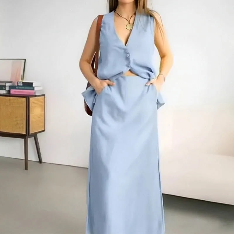 Women's loose fit blue polyester two-piece suit with sleeveless vest and long skirt.