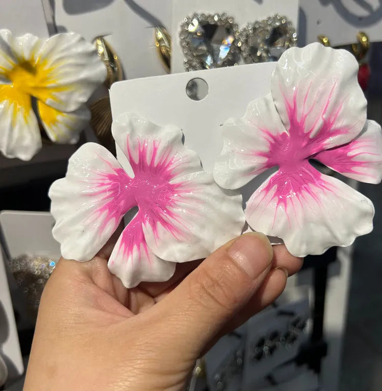 Close-up of pastoral style alloy flower stud earrings with oil-spot glaze in blue, green, purple, and rose colours