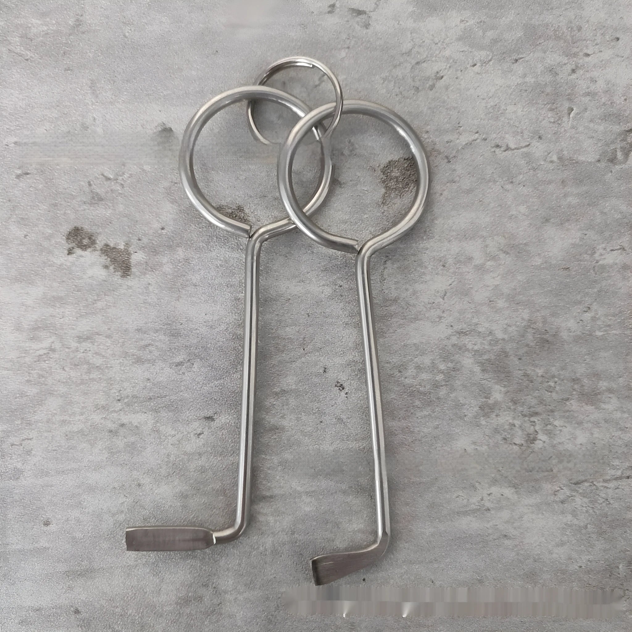 Two identical silver alloy steel wrench tools from a portable household repair set.