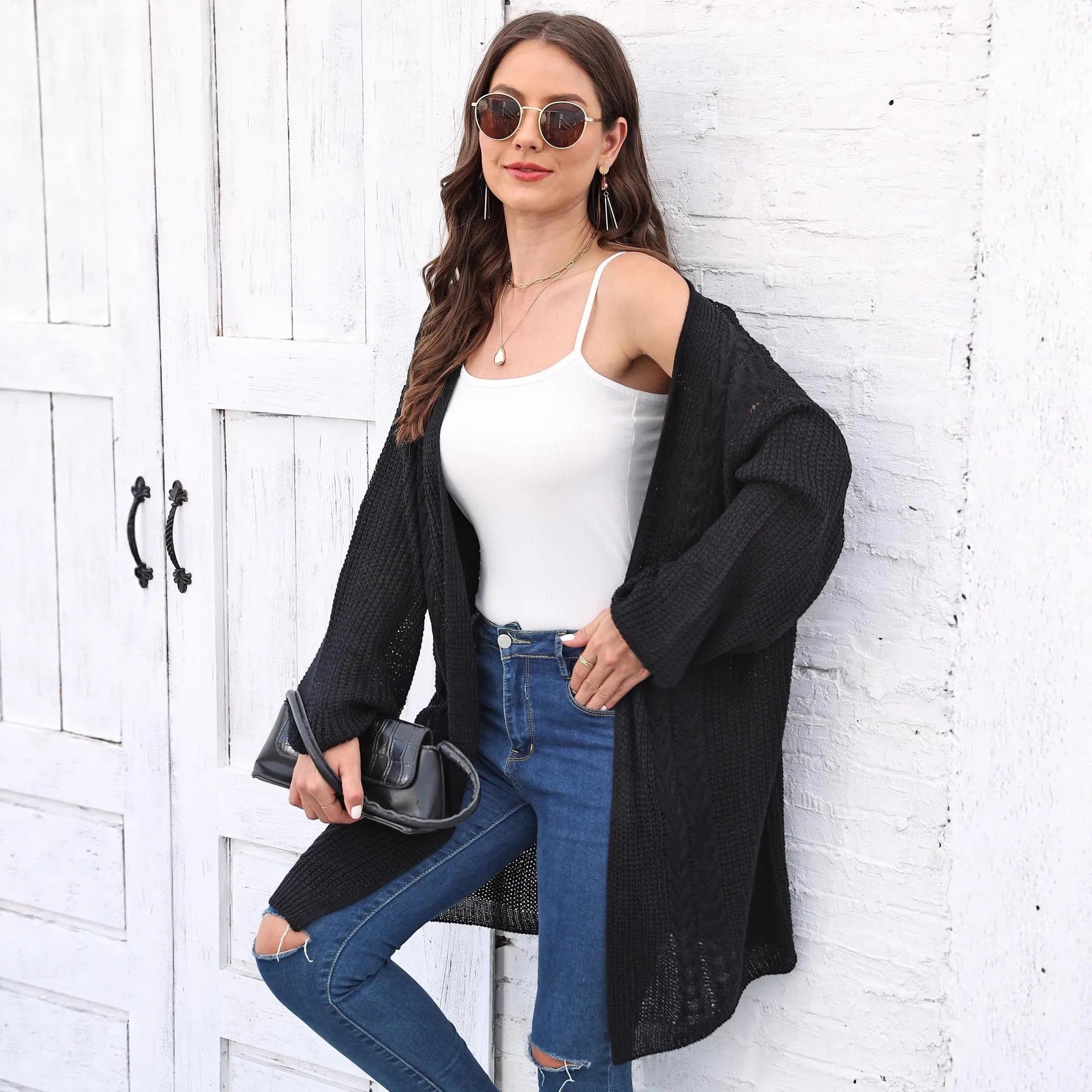 Women's loose acrylic sweater coat in solid colour on hanger