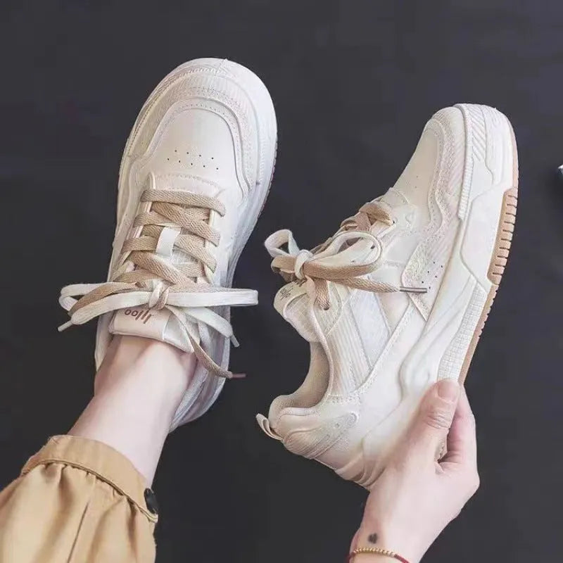 Women's beige and pink low-top rubber sneakers with height-increasing sole on a white background