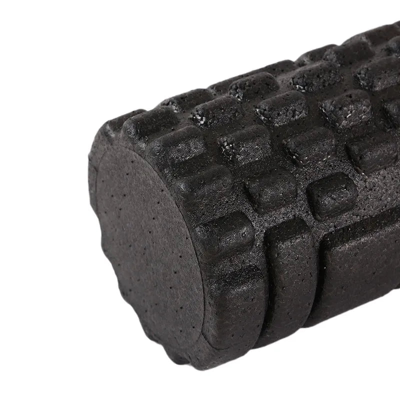 Hollow black EPP foam roller 33x14cm on flat surface for Pilates and balance exercises
