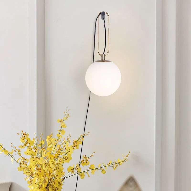Modern Nordic glass wall lamp with three light colour options on a contemporary wall