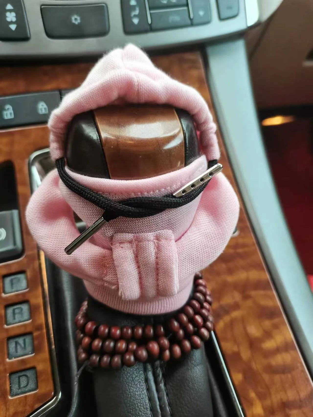 Dutch velvet car gear handle sleeve cover in multiple colours on a car gear lever.