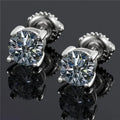 Silver four-claw set moissanite stud earrings with geometric shape and screw-back fittings.