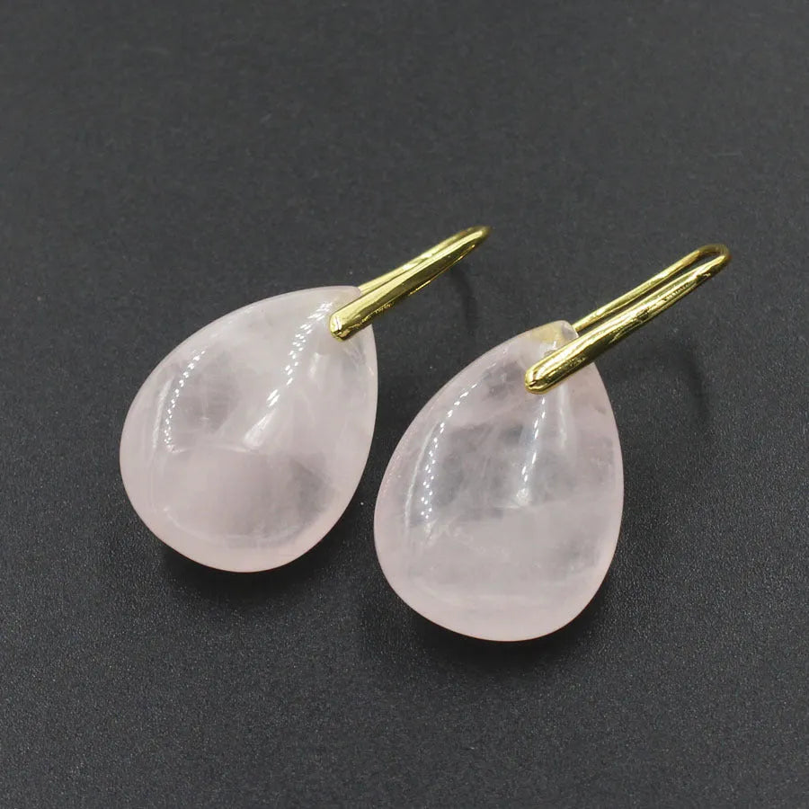A pair of geometric water drop earrings made from crystal, shown in one of nine available colours like amethyst or obsidian.