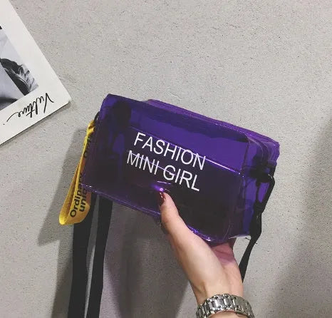 Transparent square women's shoulder bag in jelly material with a diagonal cross strap, showing internal mobile phone pocket.