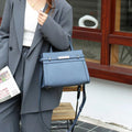 Small square genuine leather shoulder bag in horizontal design with organised interior compartments