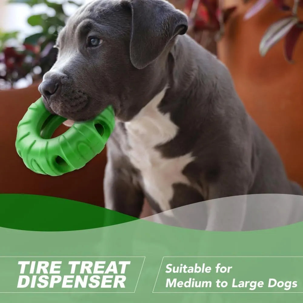 Blue rubber tire-shaped dog chew toy with oval openings for treat dispensing on a white background.