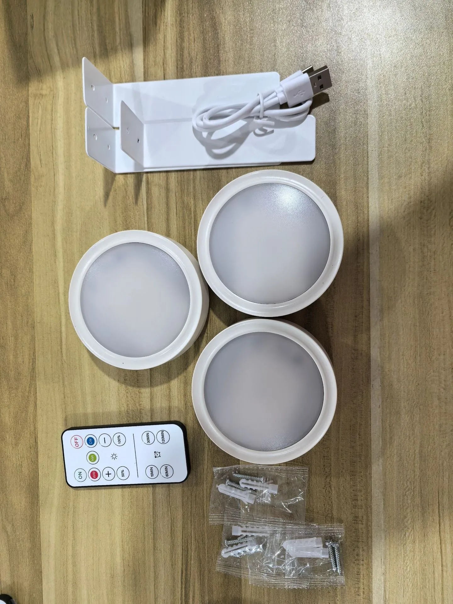Wireless rechargeable LED painting lamp with magnetic belt attached to a metal frame, remote control nearby.