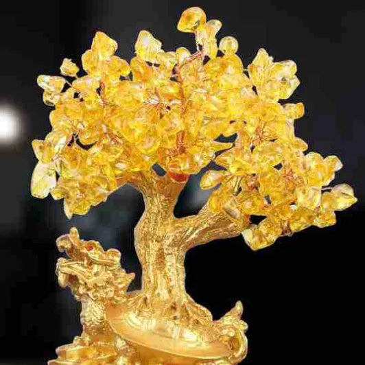 Citrine-coloured resin turtle money tree Feng Shui ornament on display.
