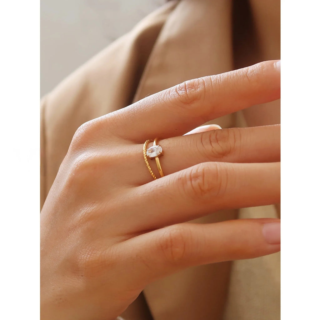 Golden stainless steel ring showing love heart and oval design options on a white background.