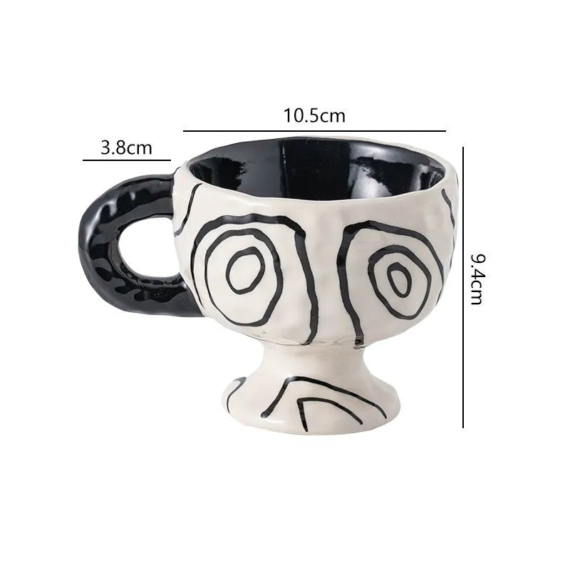Hand-pinched irregular shaped ceramic mug in a solid colour on a table.