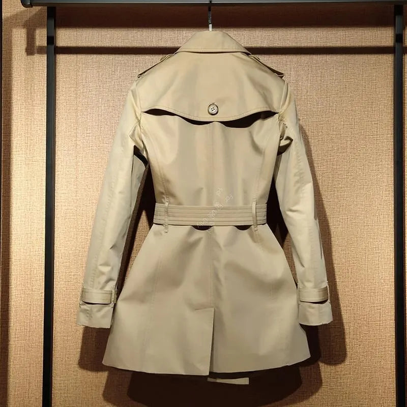 Khaki double-breasted women's trench coat with long flight sleeves, shown on a hanger.